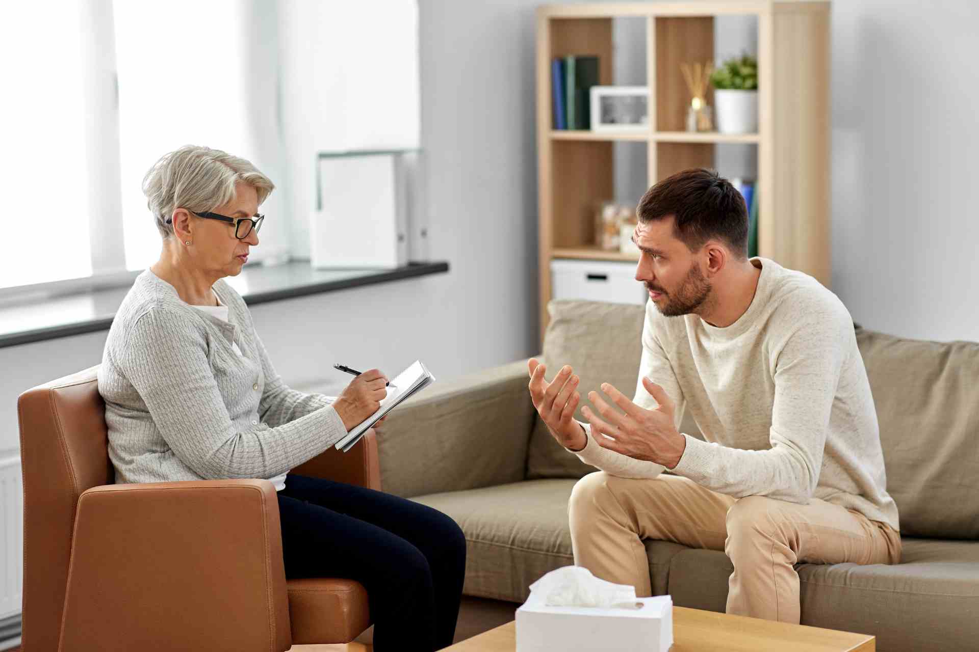 Man attending outpatient addiction therapy session.