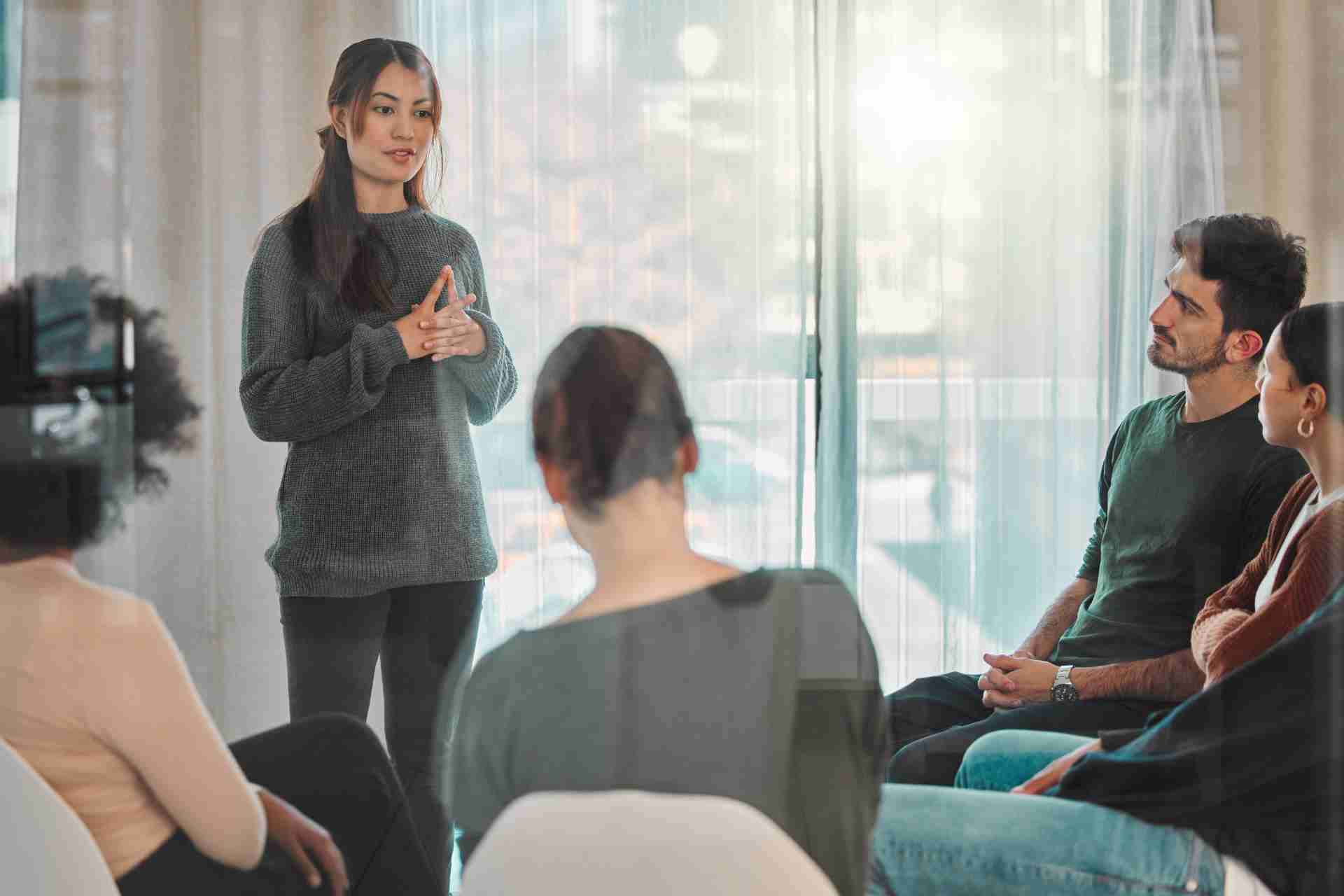 Family comforting loved one during addiction support meeting