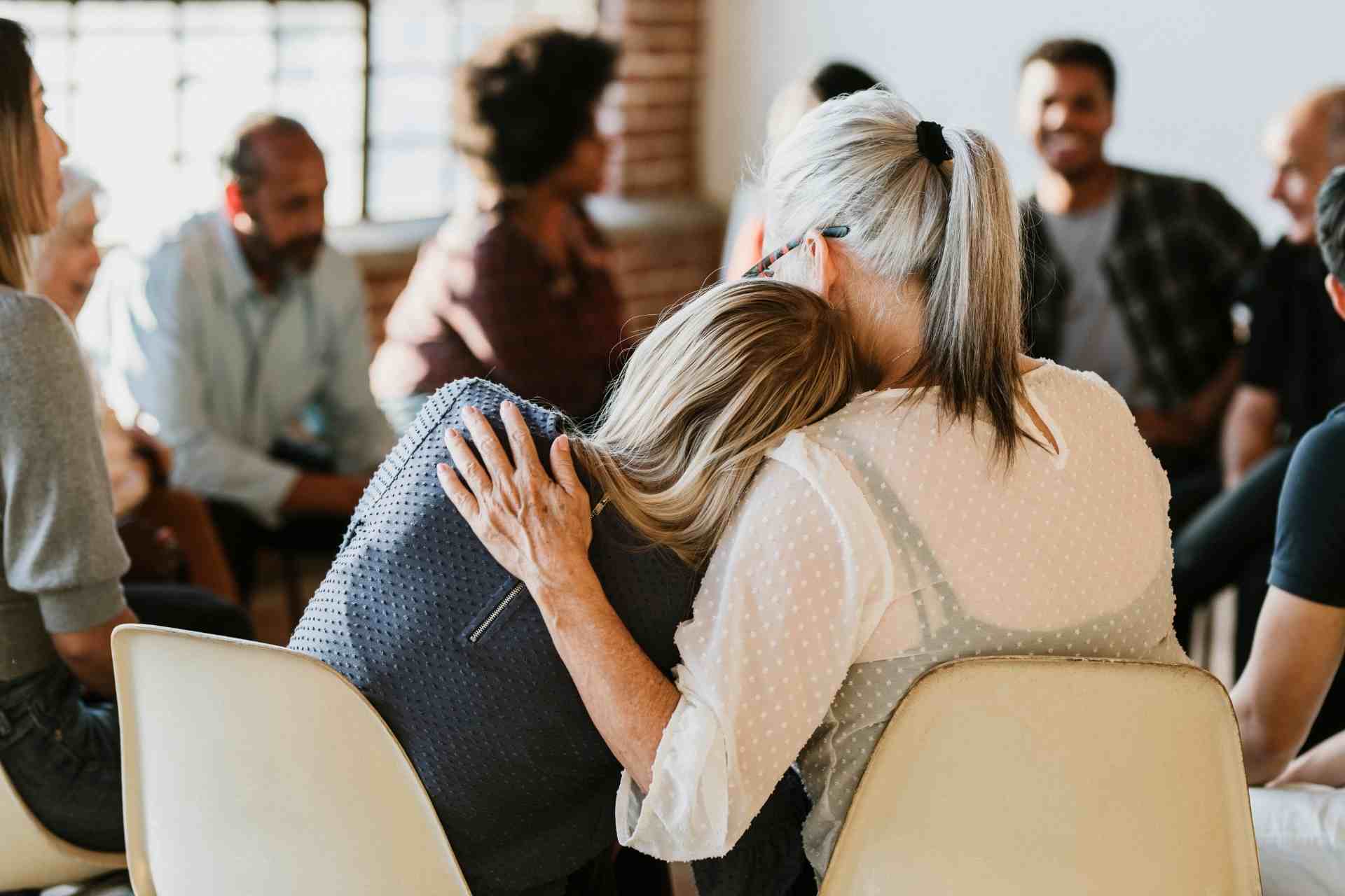 Person comforting another during addiction recovery support group therapy in New Jersey
