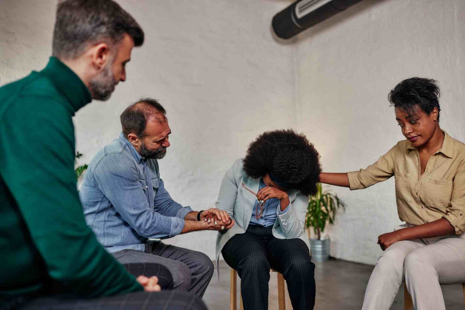 Family members supporting a person during an addiction intervention session