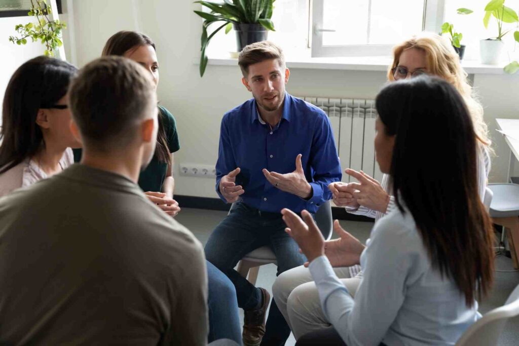 Group therapy session discussing residential treatment vs IOP in New Jersey
