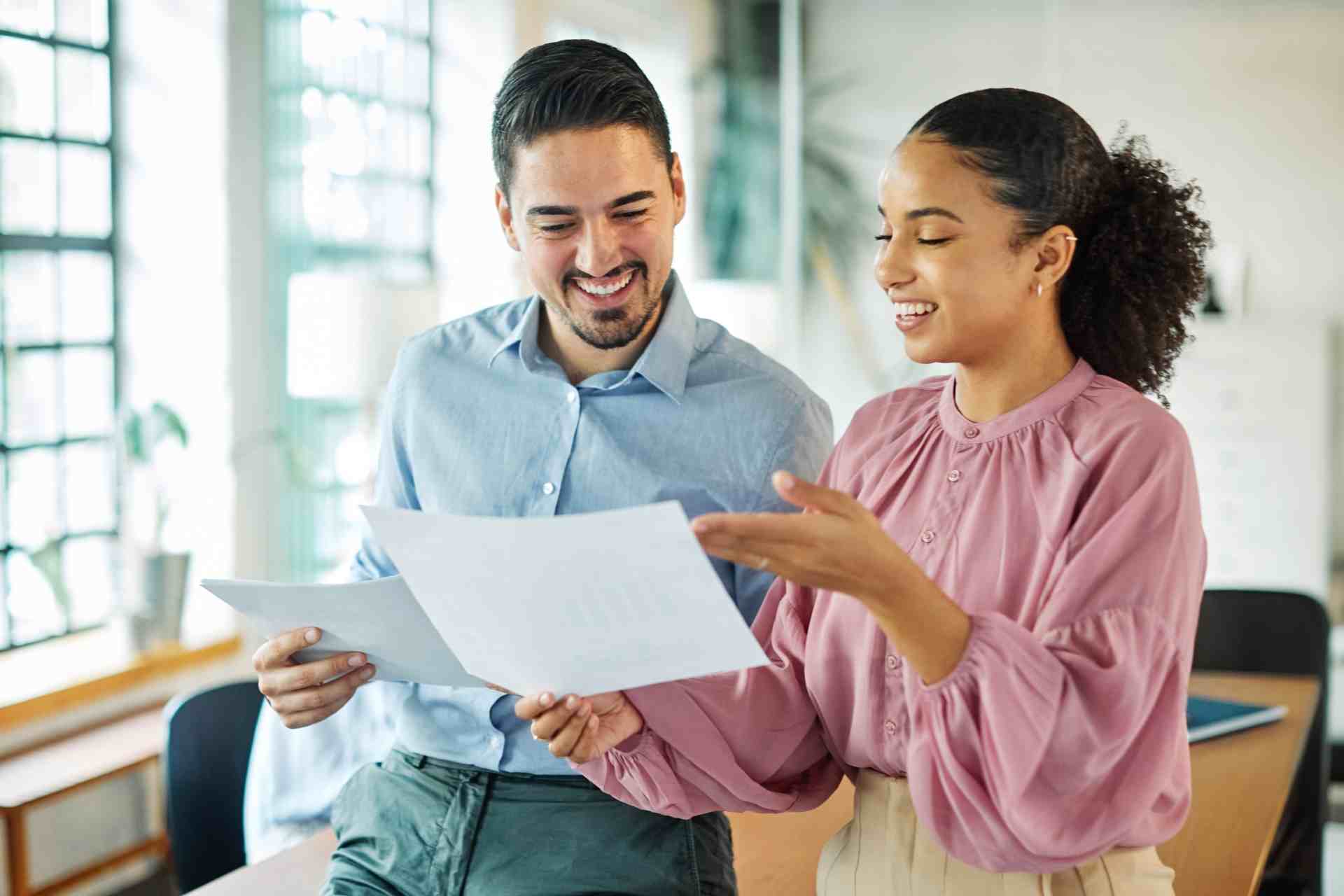 Two people reviewing insurance paperwork for addiction treatment coverage in New Jersey
